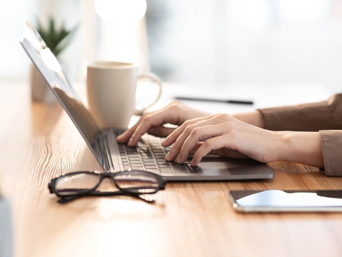 woman typing on a laptop keyboard