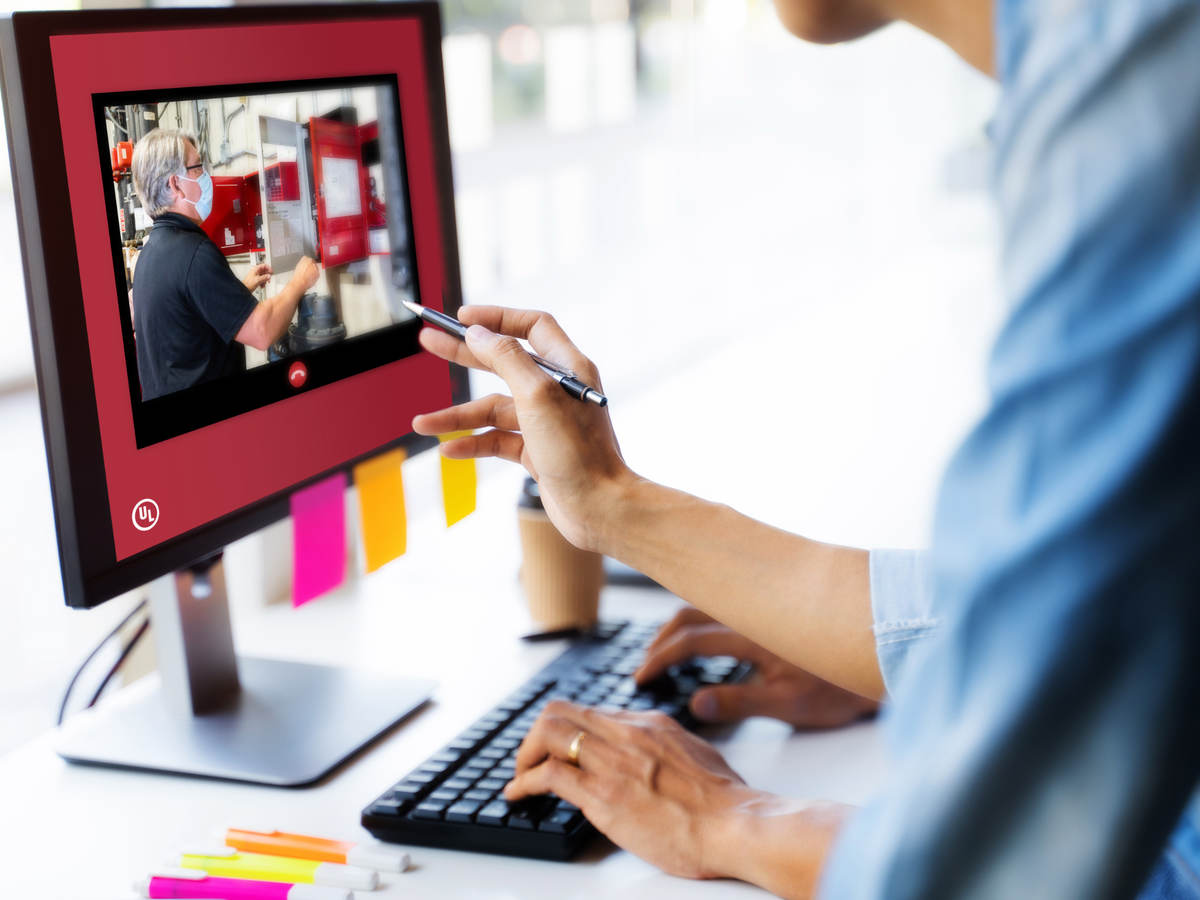 People collaborating looking at a computer monitor