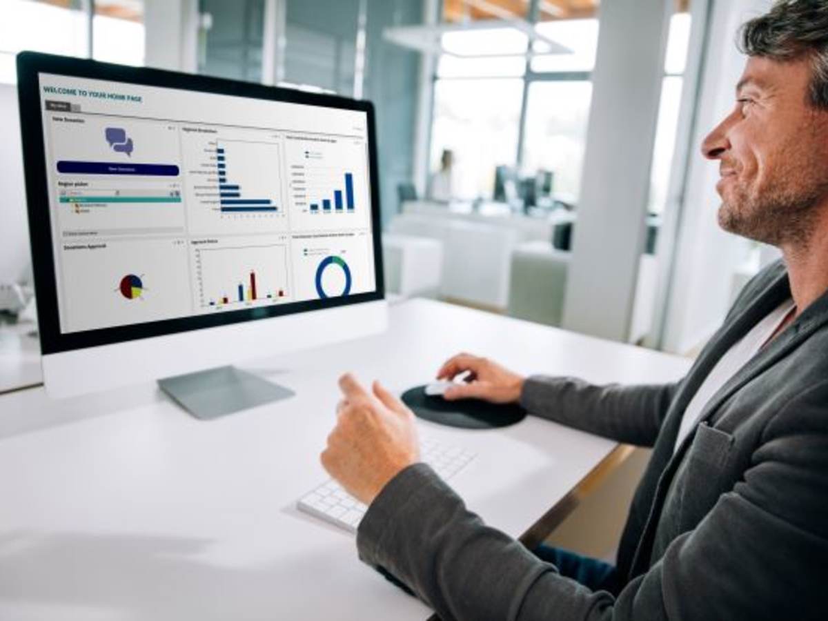 man at computer with data on screen