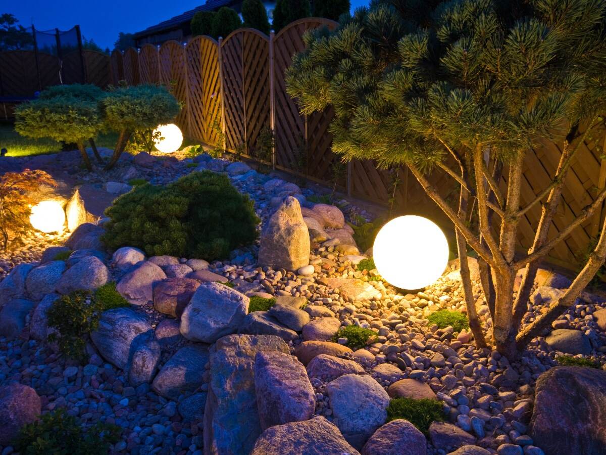 Home garden at night, illuminated by globe shaped lights