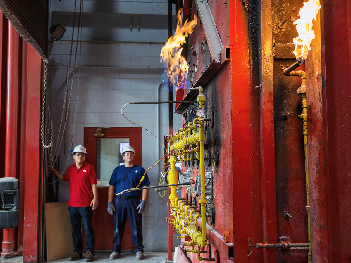 Two engineers performing a column fire test