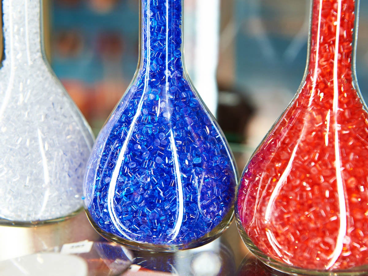 Colorful plastic granular polymer in glass flasks