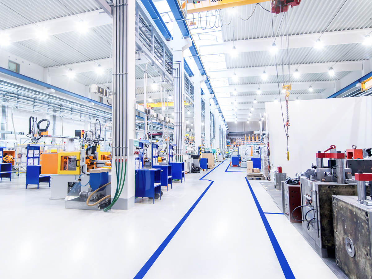 View overlooking the digitally controlled lighting of a brightly lit modern factory floor.