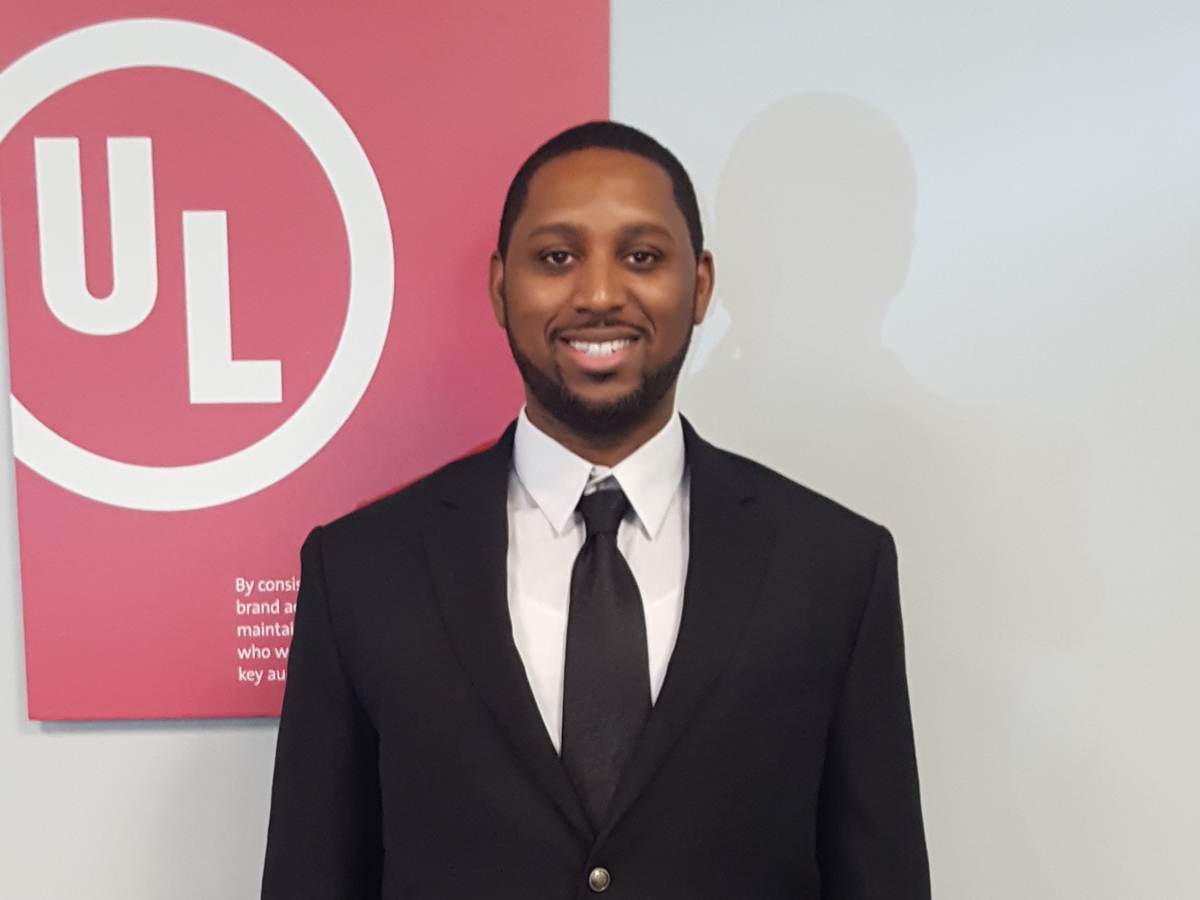 Melvin Beasley poses pre-pandemic in front of UL board.