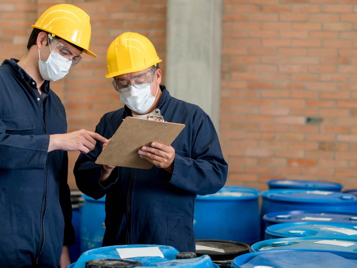 Men in PPE working in chemical warehouse