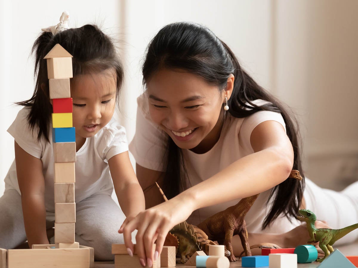 Mother and child playing with toys together