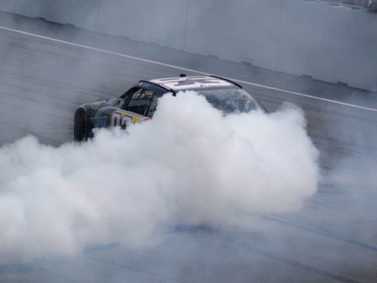 Race car drifting with smoke behind it