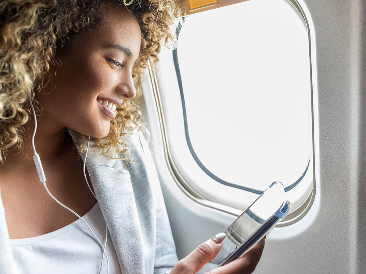 Woman with cell phone on flight