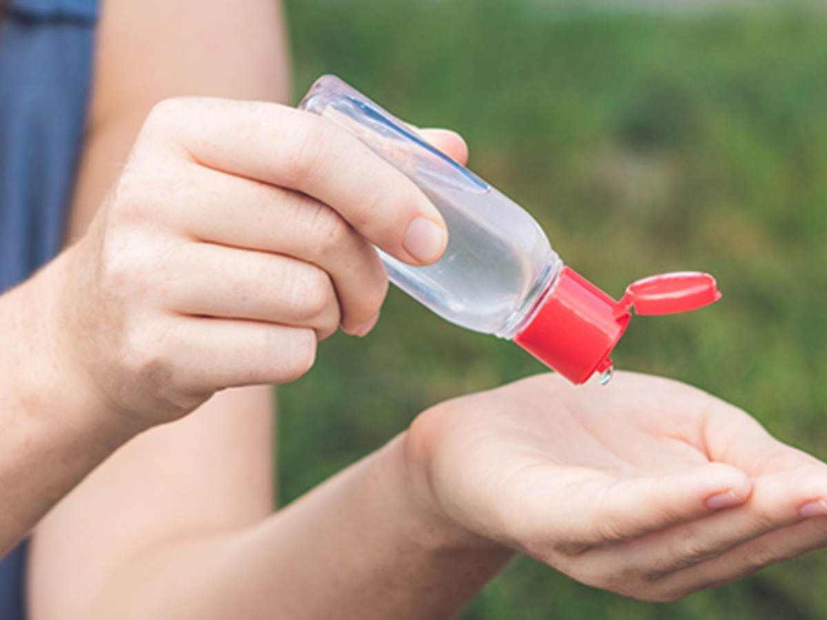 Woman using hand sanitizer 