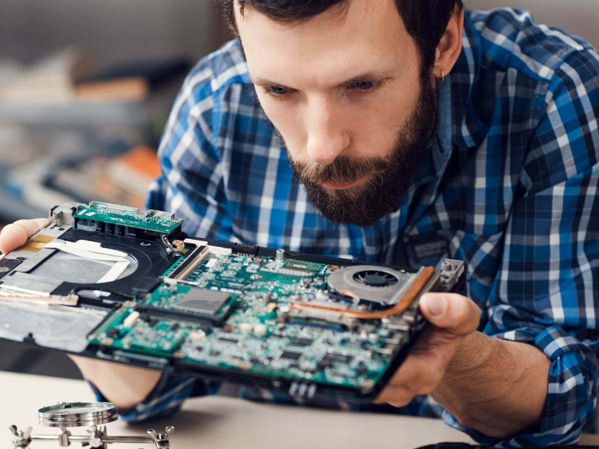 Engineer studying computer motherboard