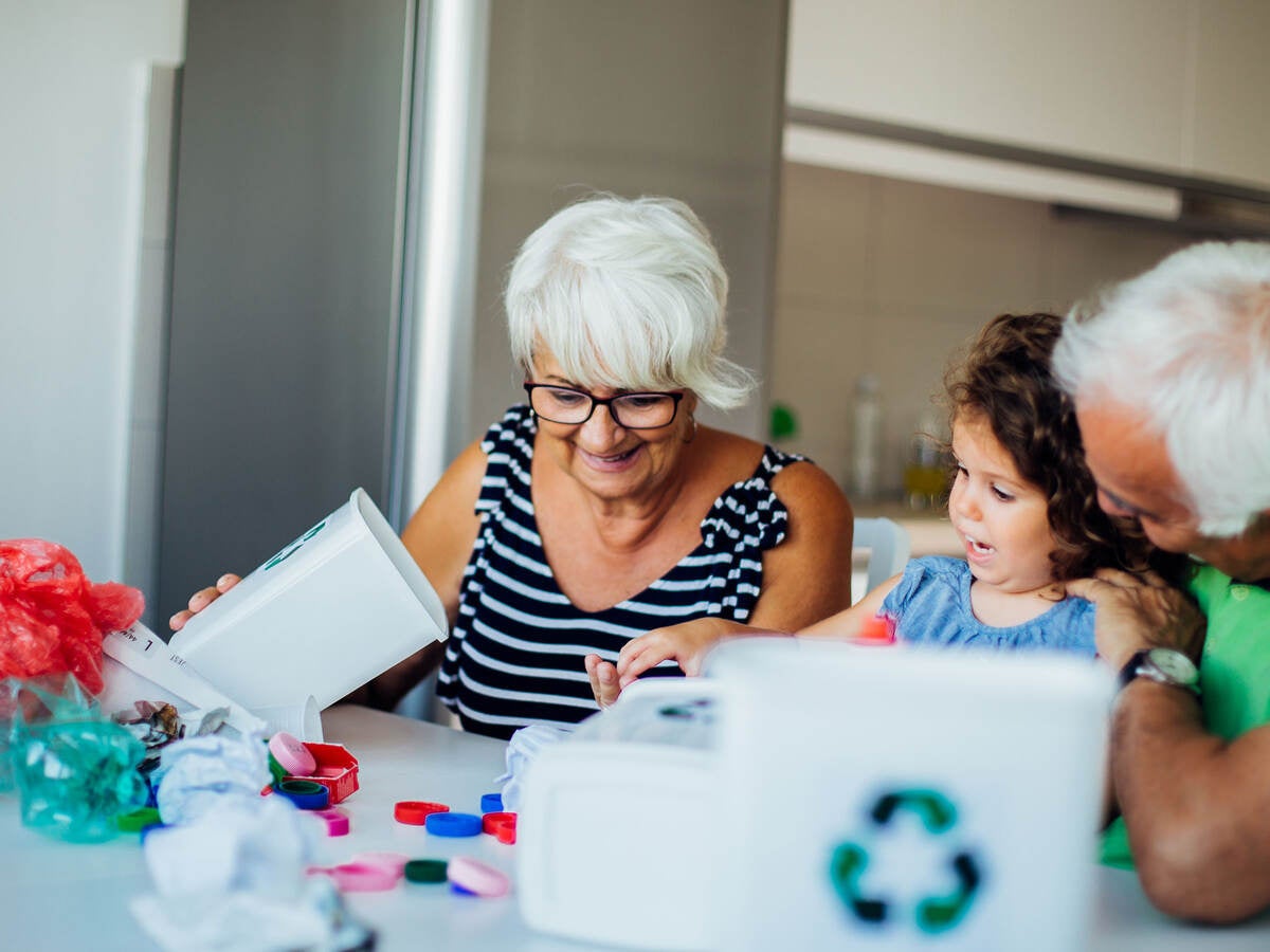 Grandparents sort recyclables with their grandchild