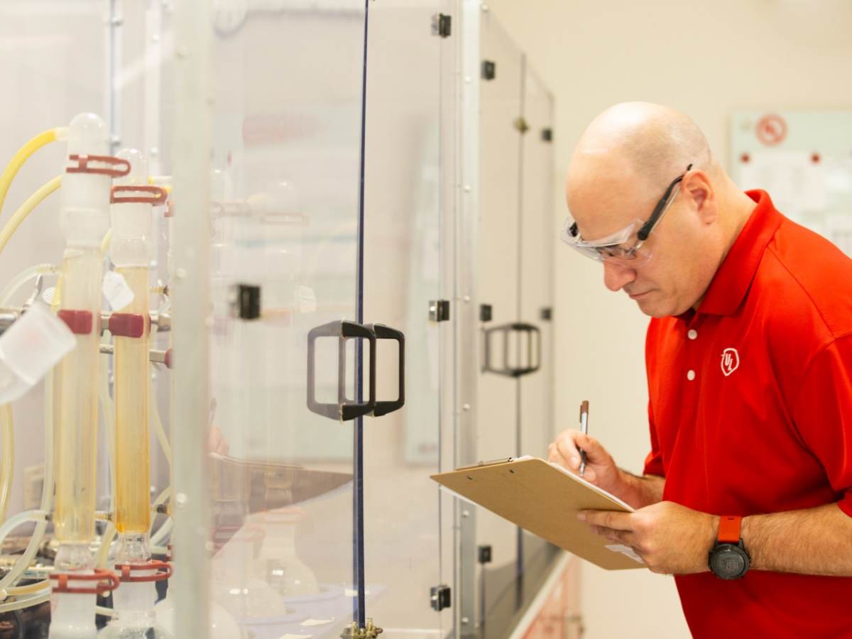 Laboratory professional with clipboard observing products