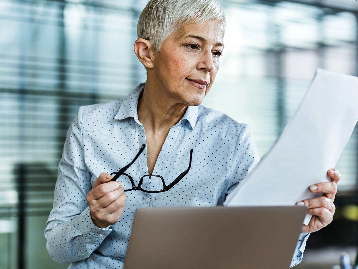 Woman looking at market share documents 