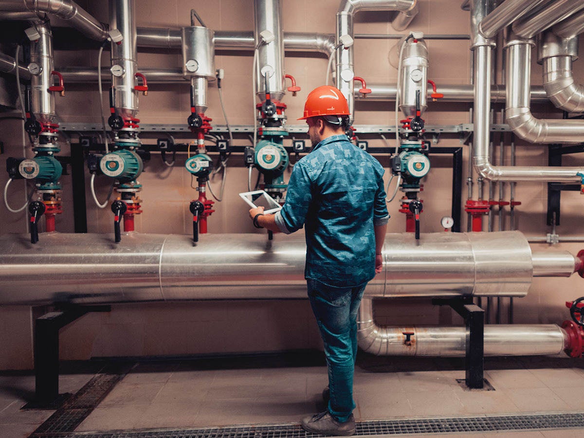 Electrical engineer working in an industrial boiler control room