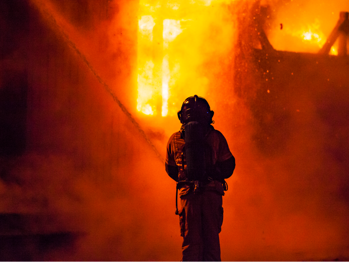 Firefighter and fire at night