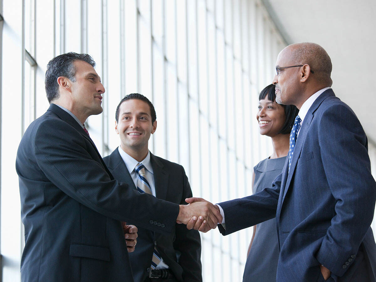 Smiling business people shaking hands