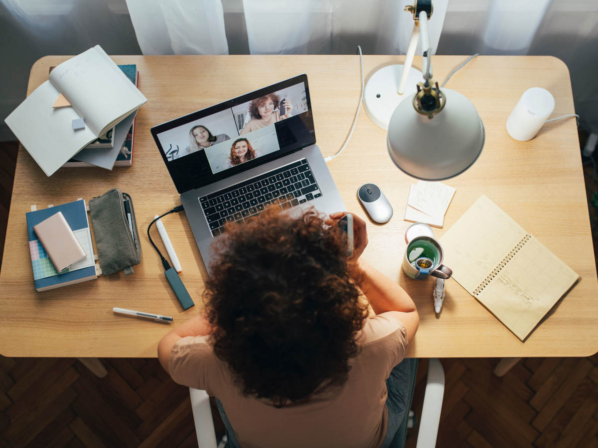 Woman on laptop learning and interacting with others