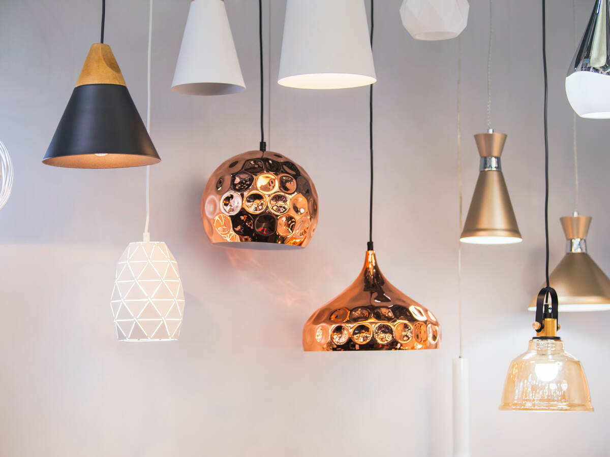 A variety of lighting fixtures hanging together in a retail setting.