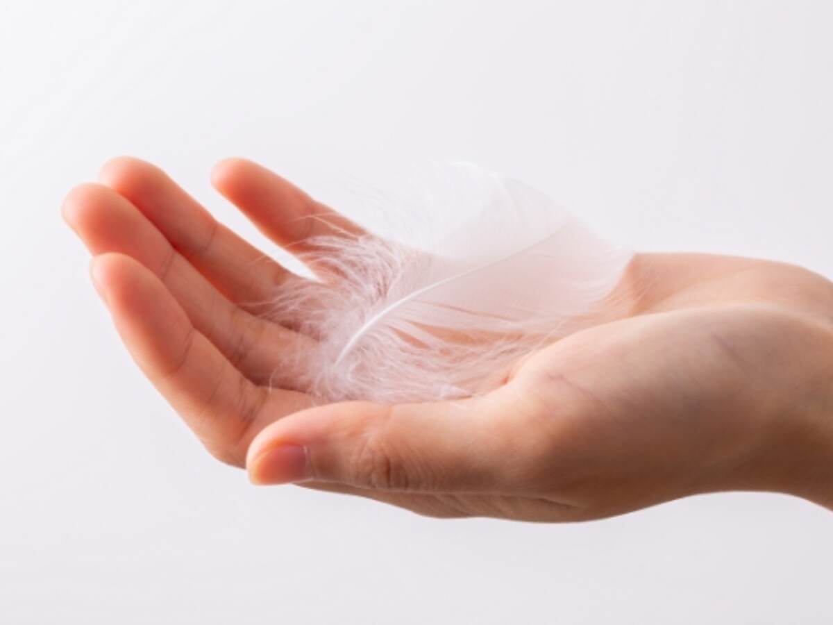 White feather on a woman hand