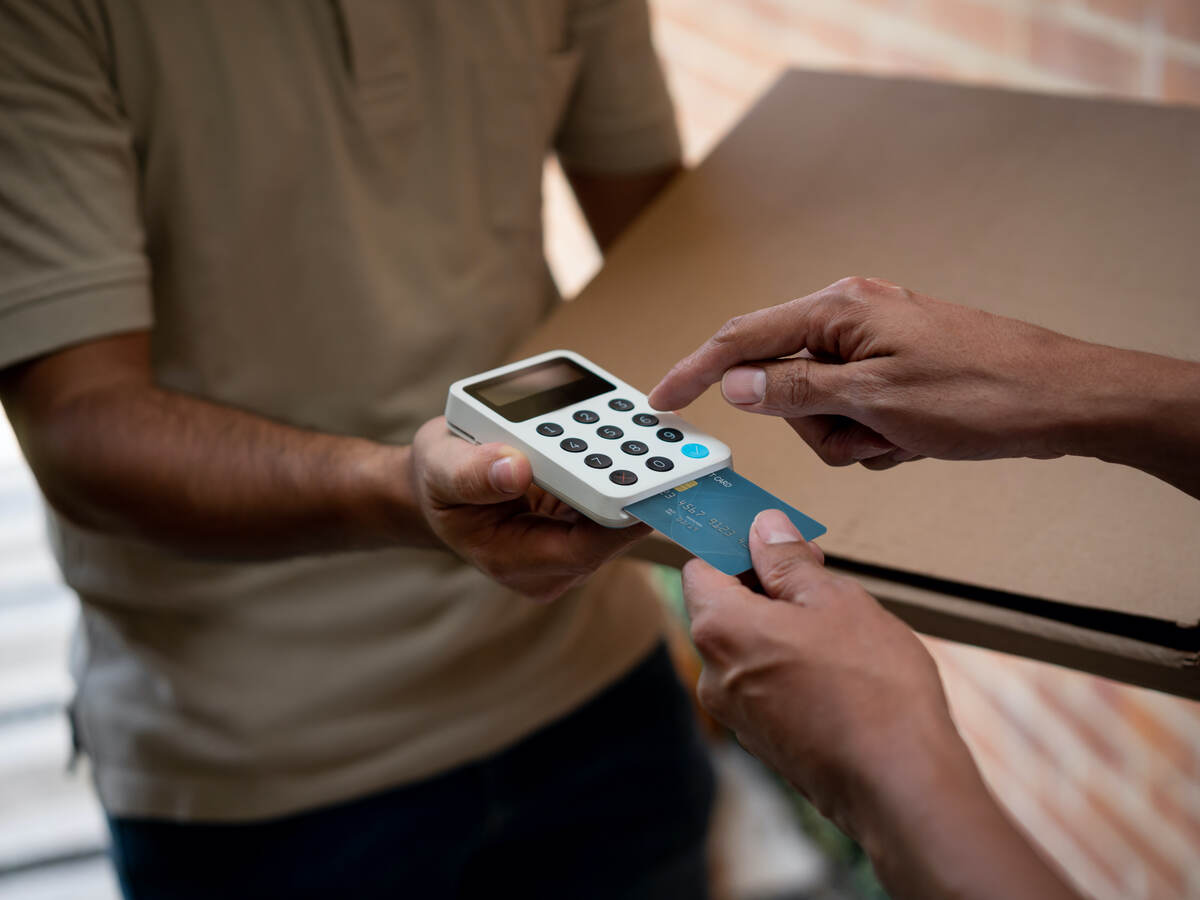 man entering PIN code for payment