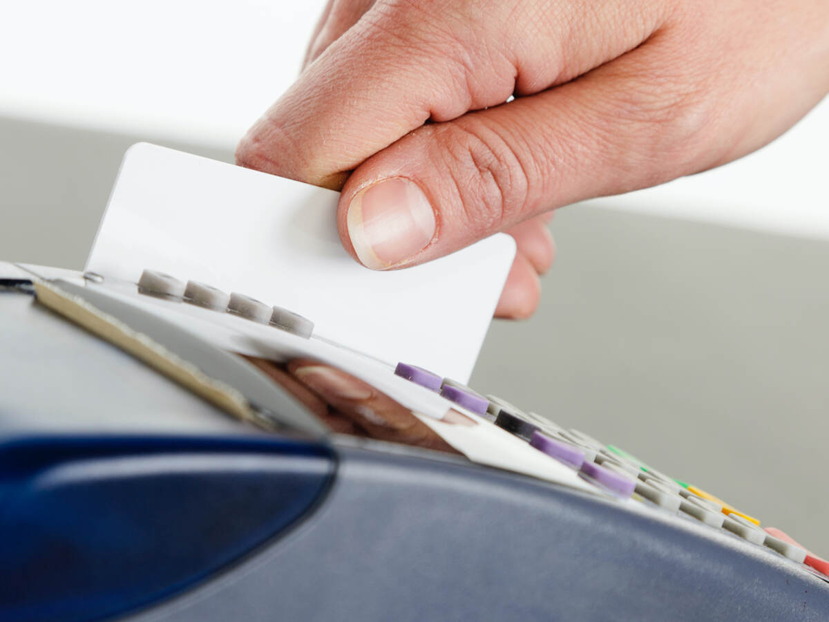 man swiping a credit card for payment