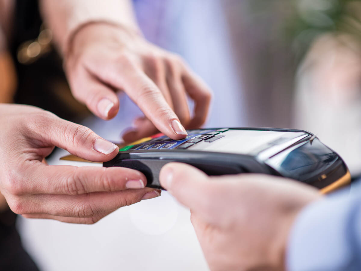 woman entering PIN code for payment