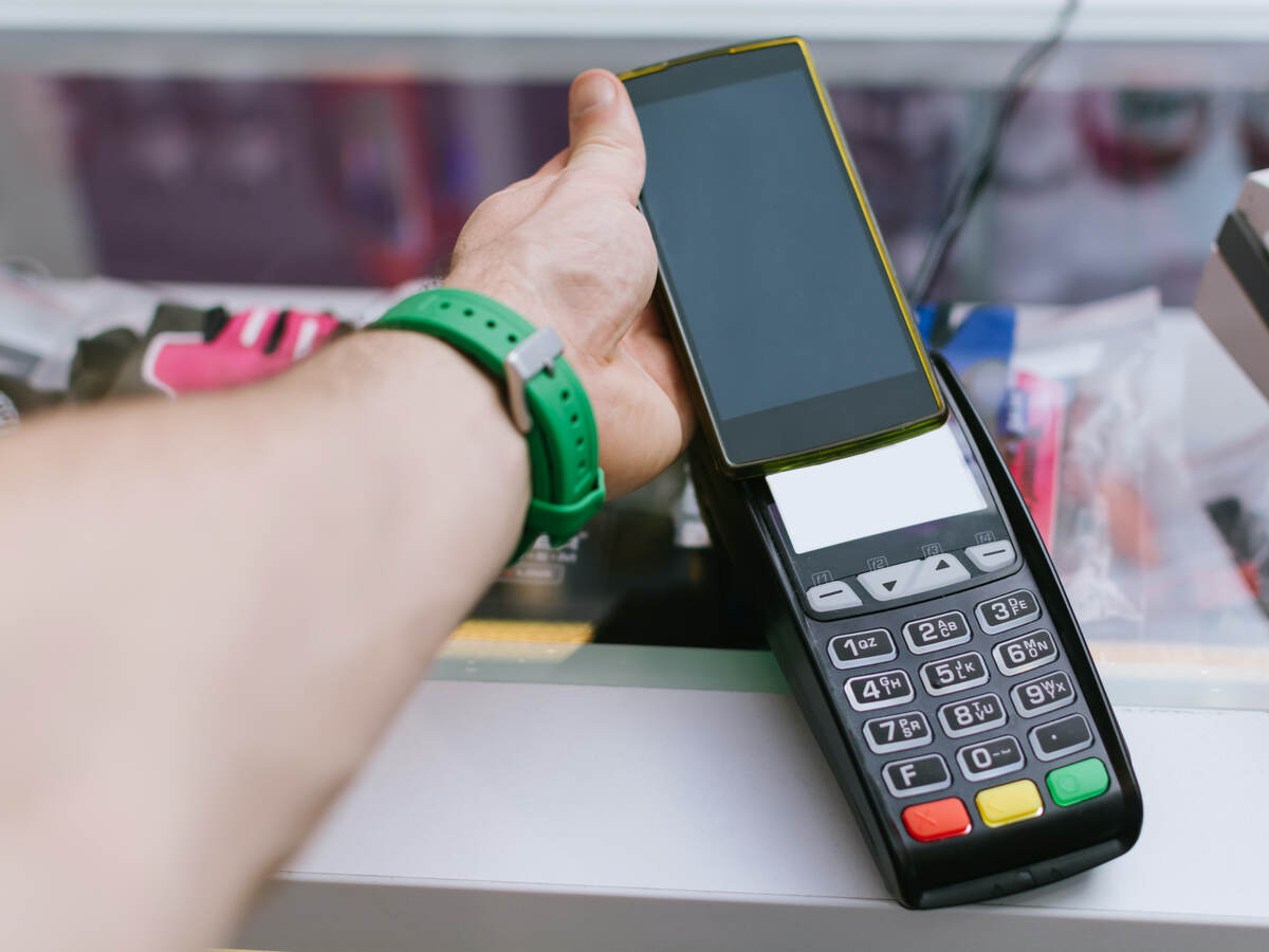 man tapping a mobile phone for payment