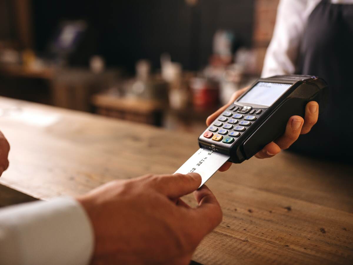 customer doing payment with a credit card in cafe