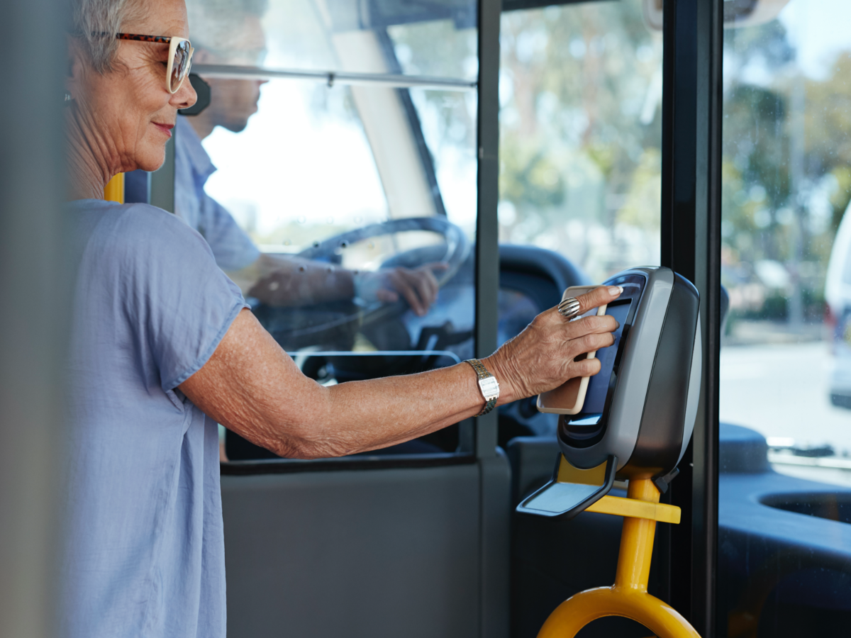 woman tapping a card in a bus