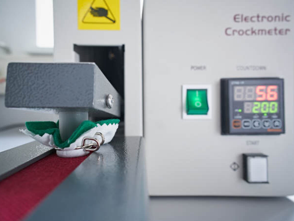 Electronic crockmeter conducting test on fabric sample