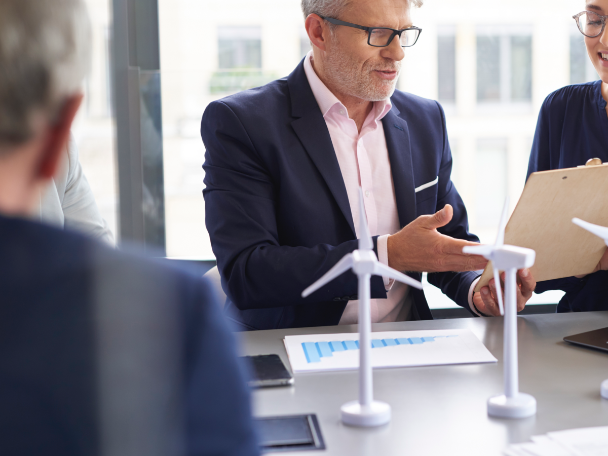 Business people discussing a wind turbine model