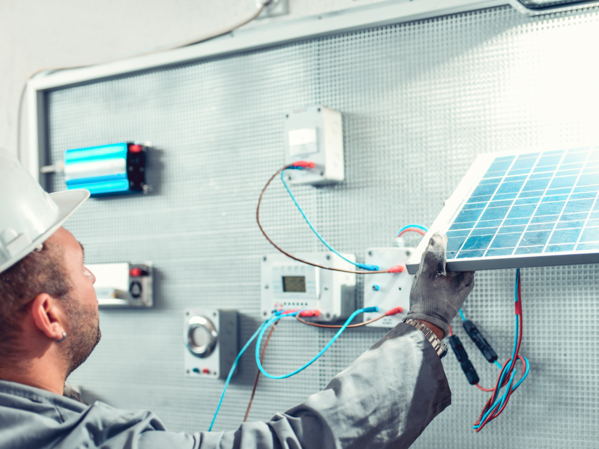 Technician installing solar panels