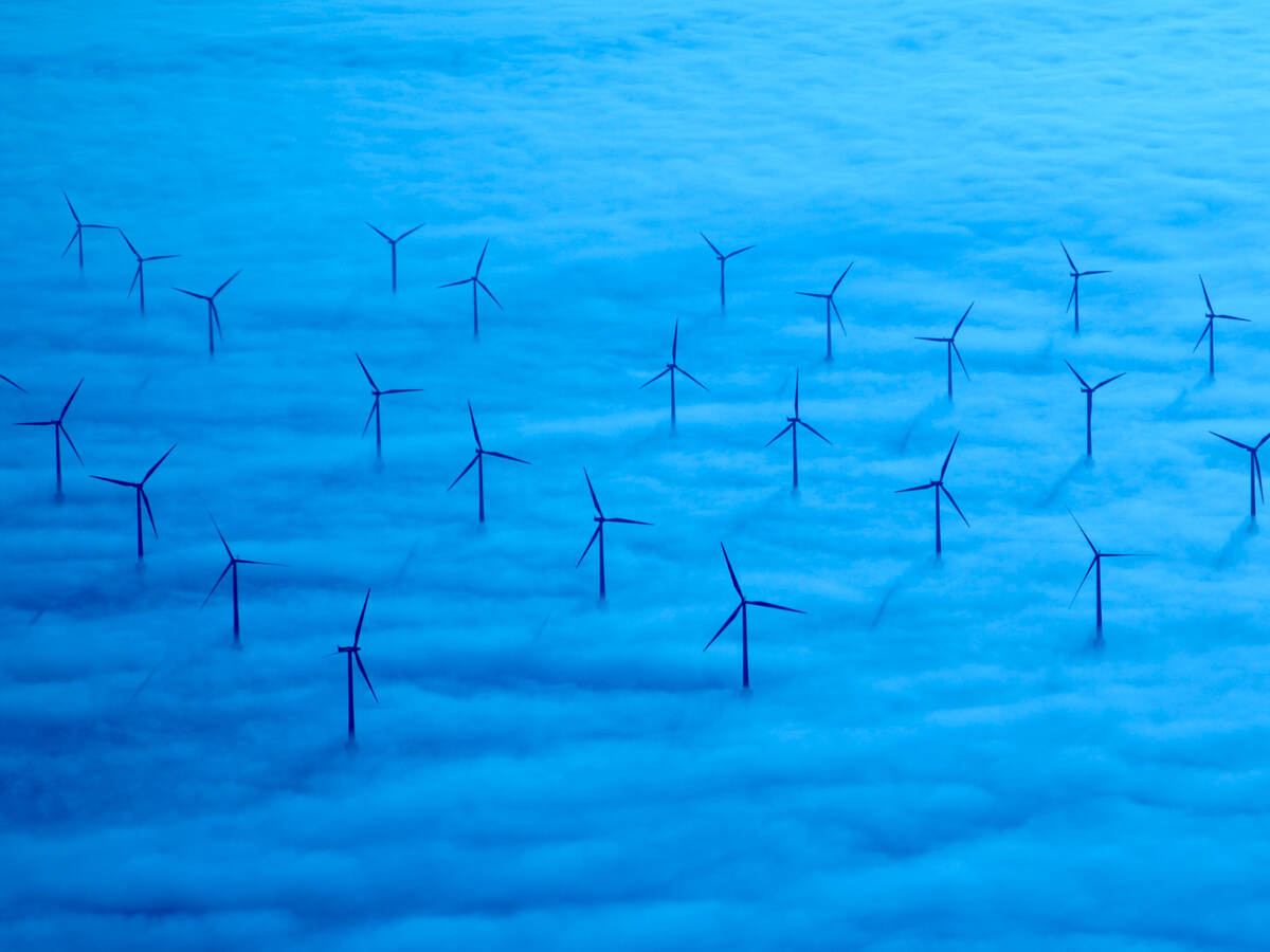 A wind farm in a sea of blue clouds