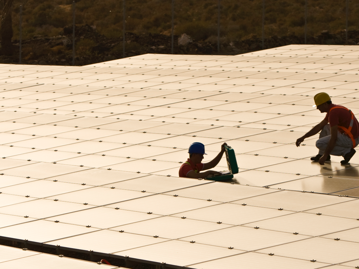 Workers installing solar panels