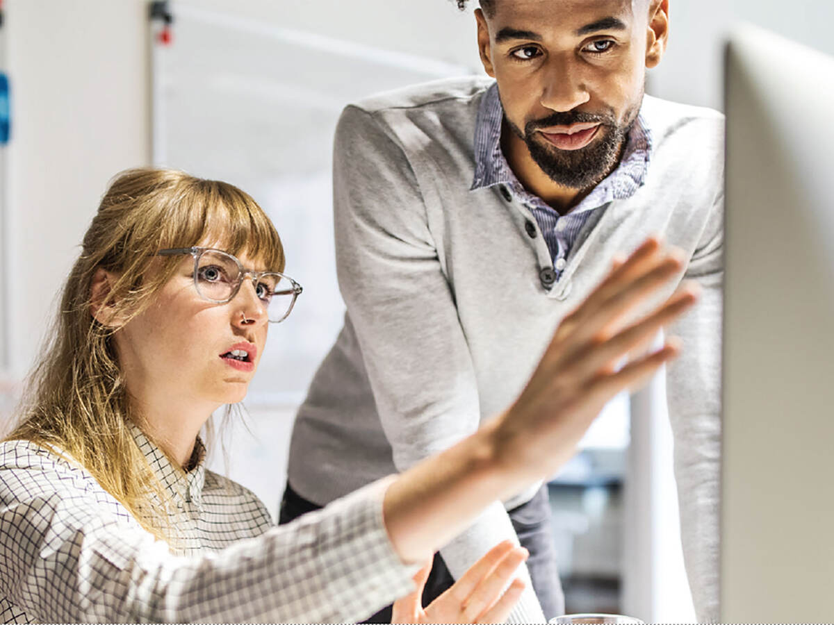 Two people looking at a monitor