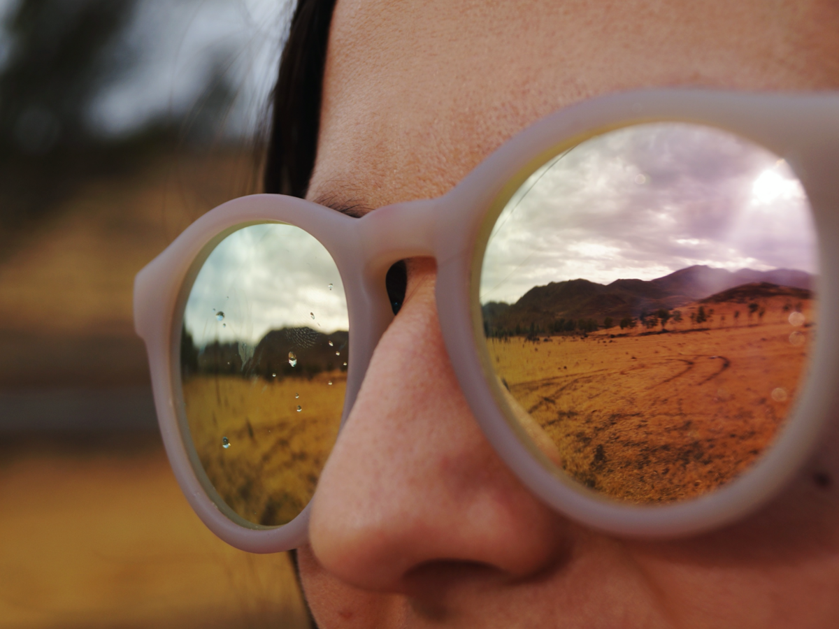 Woman with sunglasses looking at mountains