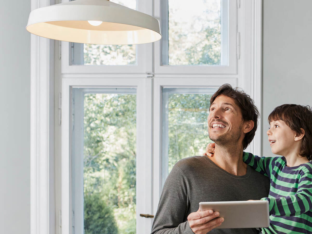 Family controlling overhead light with tablet 