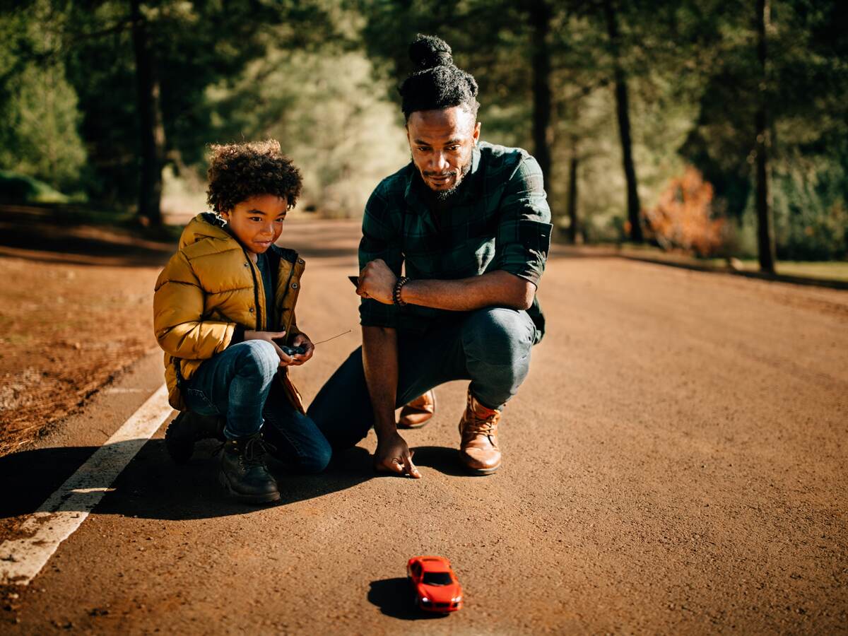 Father and a son playing with a toy