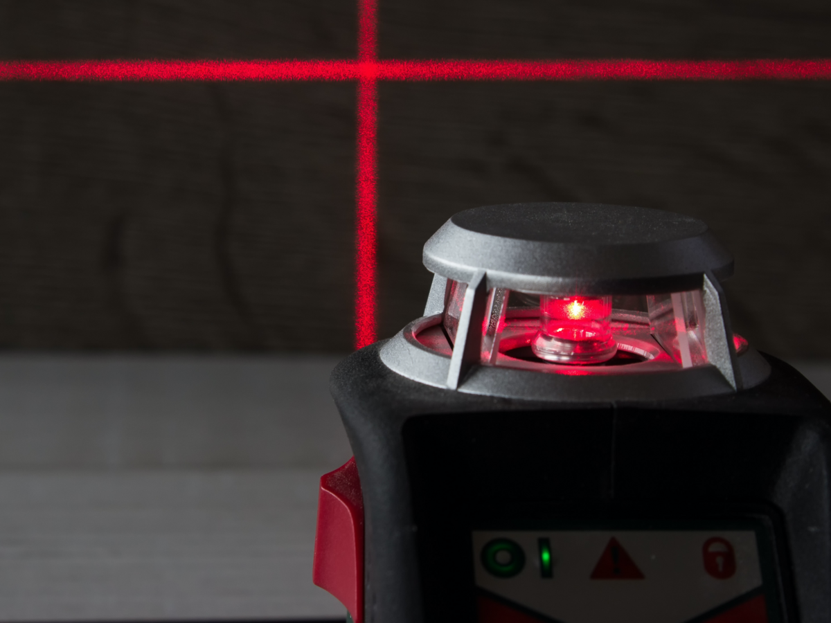 Laser emitting device with red laser beam making a grid