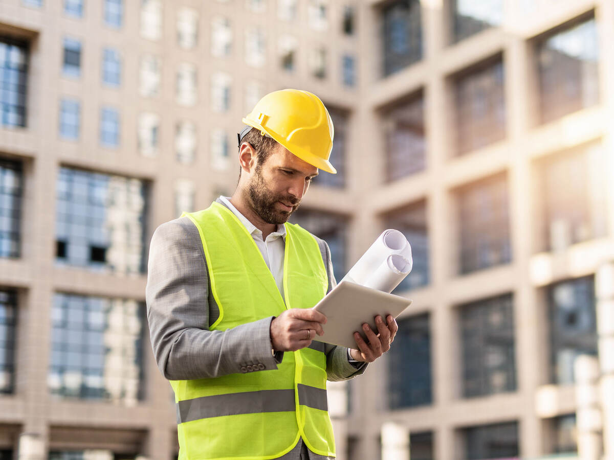 Serious engineer using digital tablet