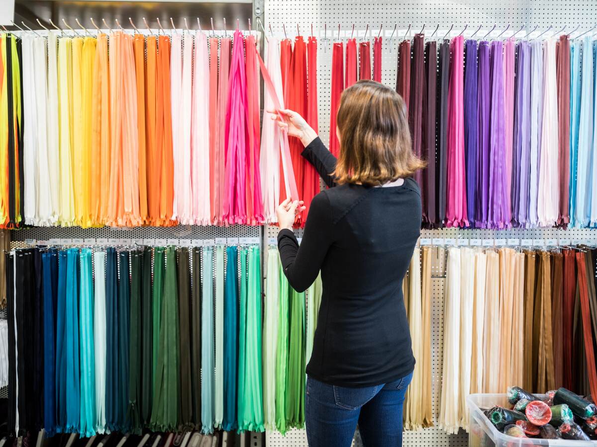 Woman examining colorful zippers