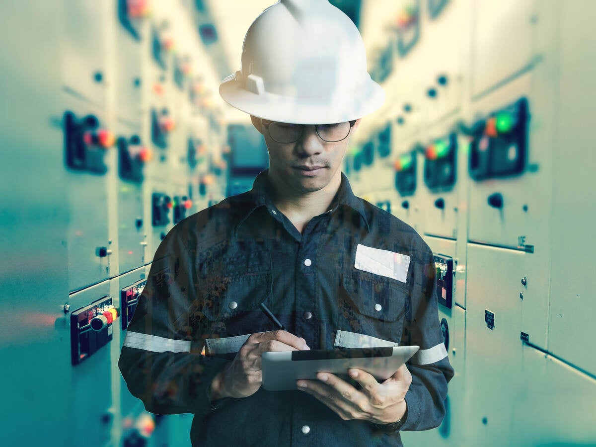 Double exposure of Engineer or Technician man working with tablet in switch gear electrical room of oil and gas platform or plant industrial for monitor process, business and industry concept.