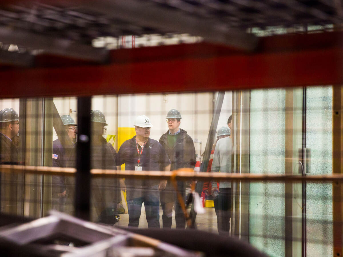 Employees discussing while standing in testing facility