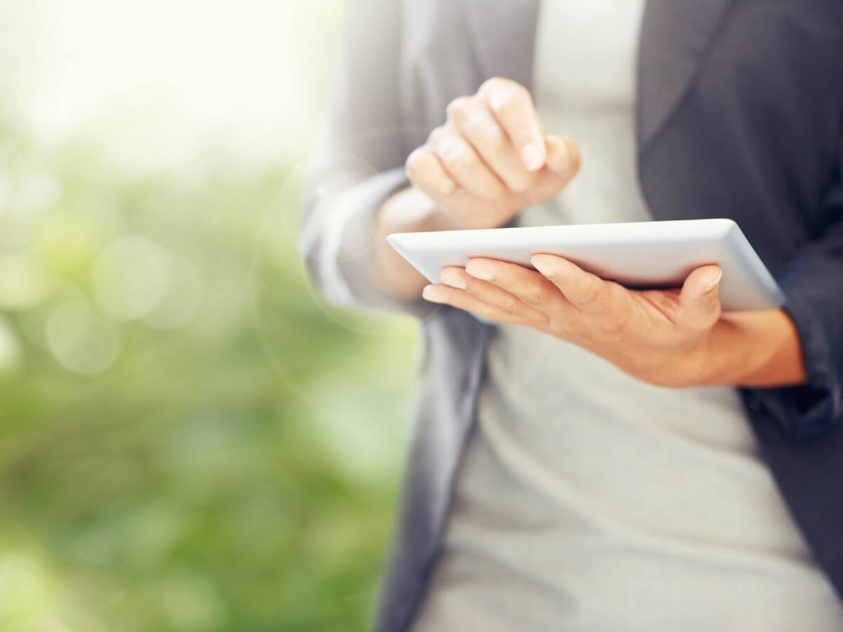 Person with tablet in nature