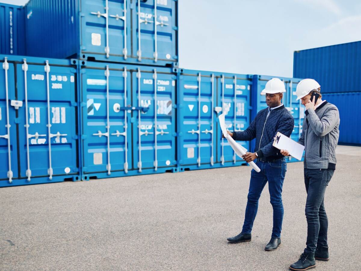 Logistics workers discussing paperwork.
