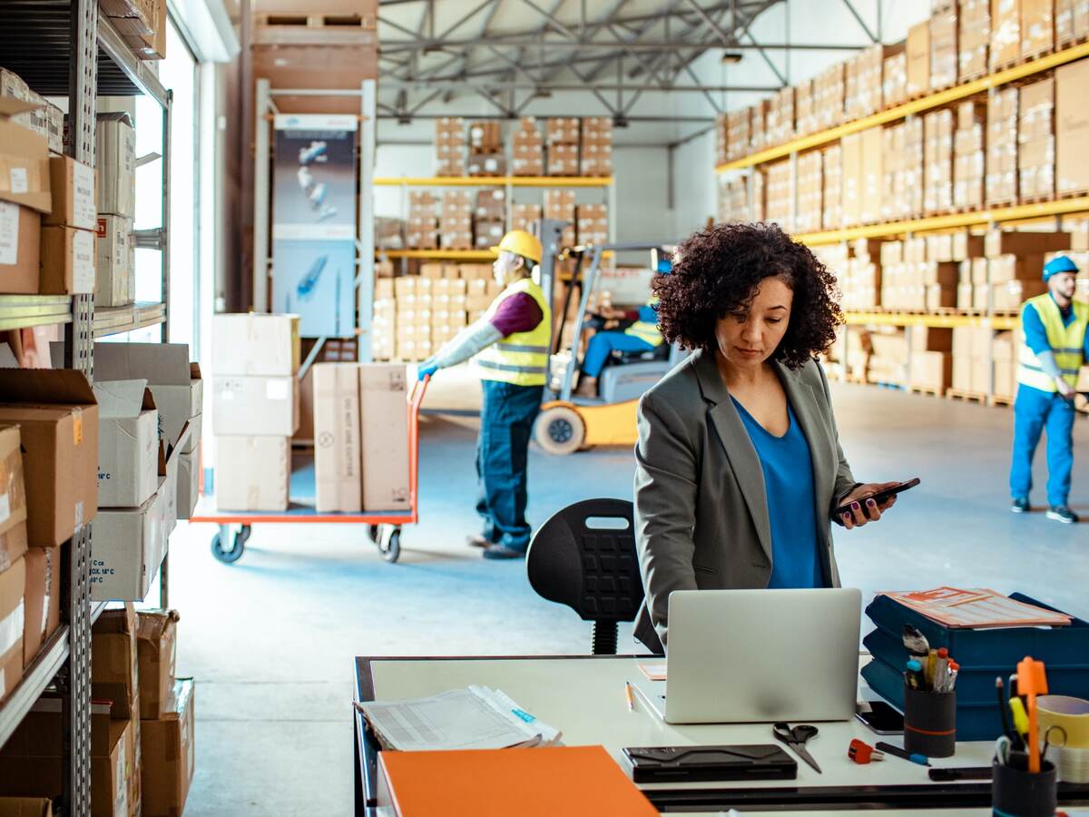 Person working on a laptop in a warehouse