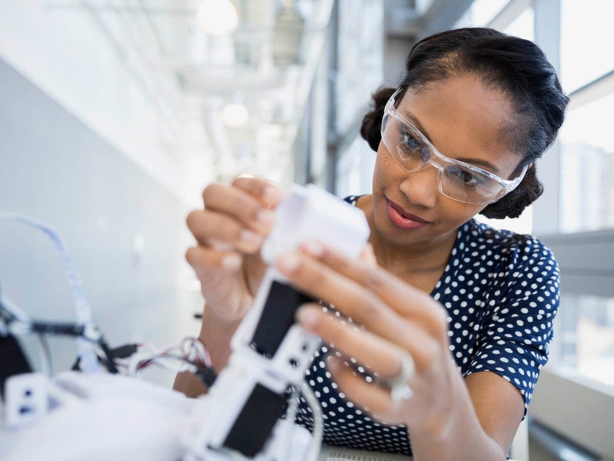 Woman looking into a microscope 