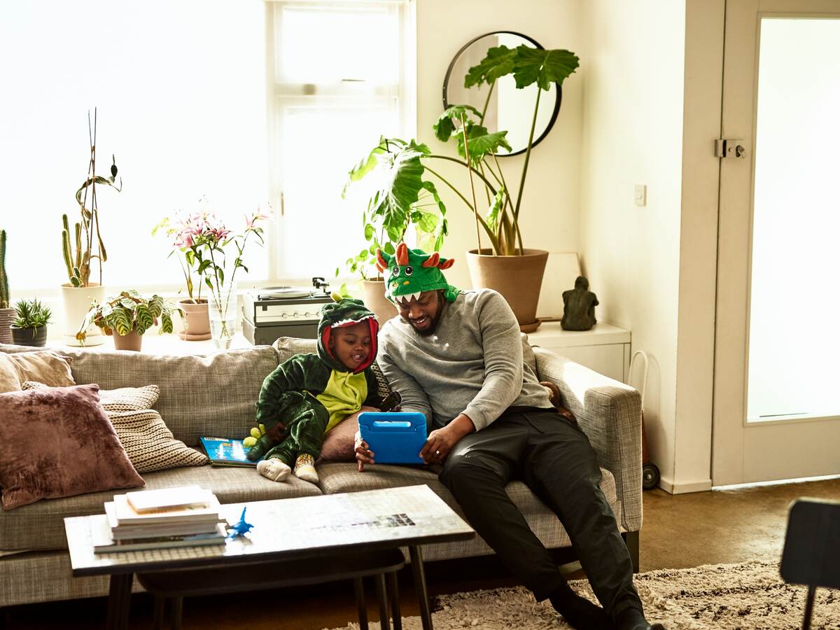 Father and son playing with a connected toy