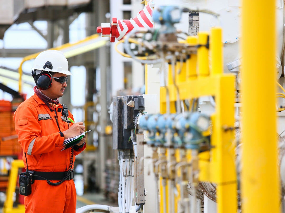 Worker checking gas pipes