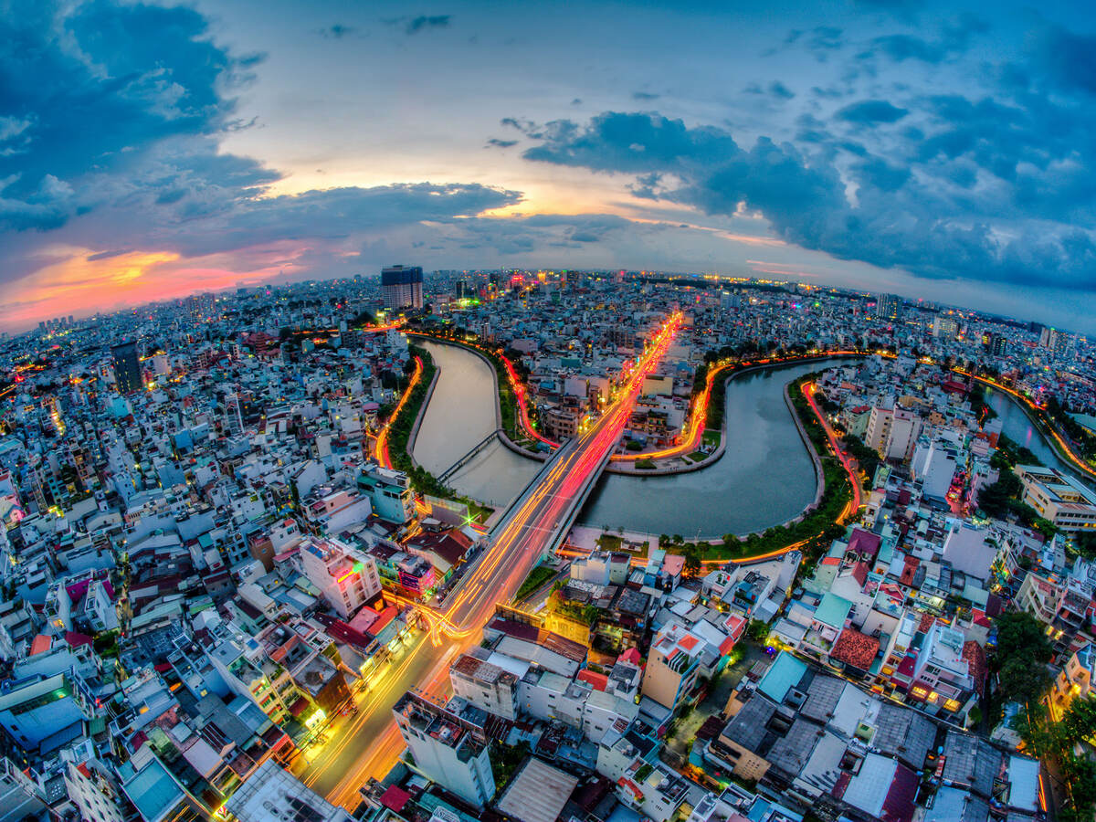 Aerial sunset view of houses and Business and Administrative Center of Ho Chi Minh City on NHIEU LOC canal